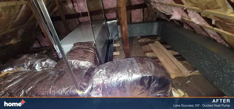 After, from the same angle: a new cabinet and a foil-wrapped plenum where the stained unit stood.