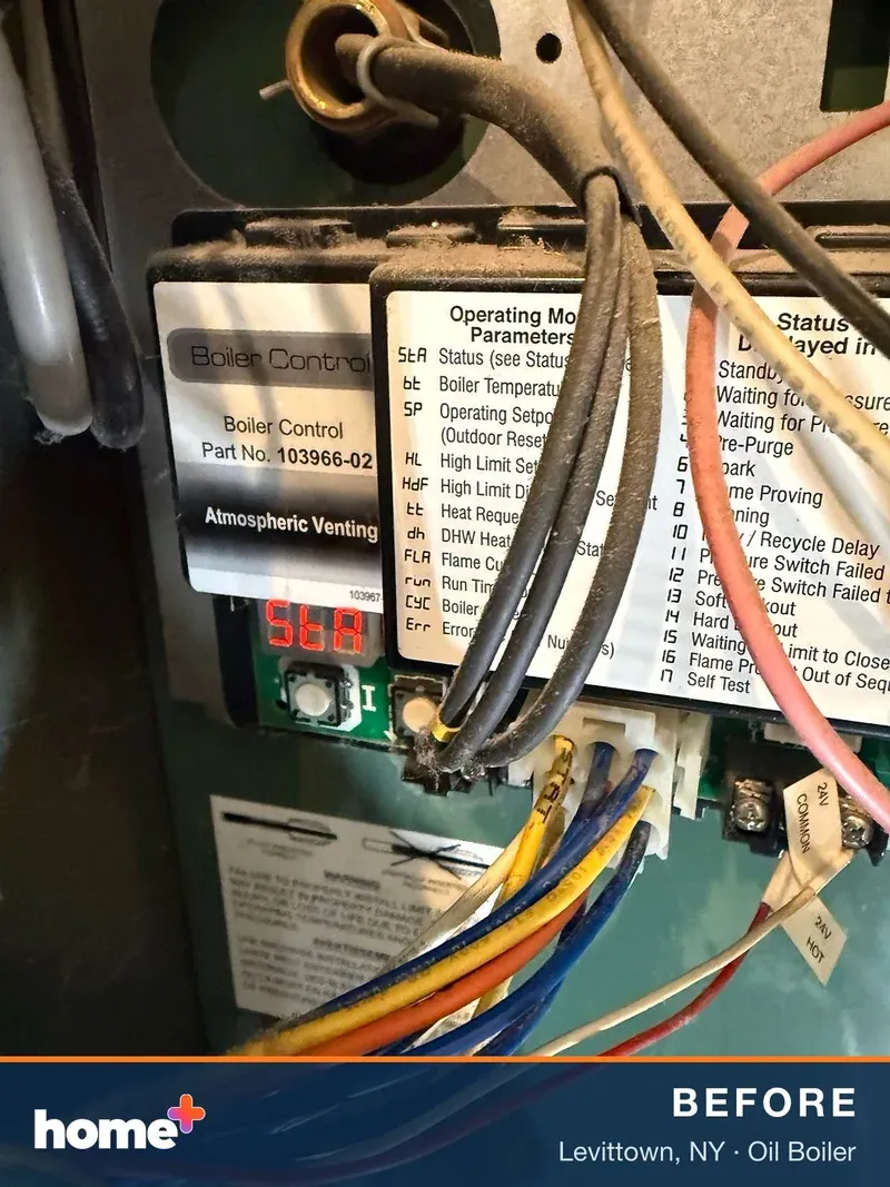 The original control board, its display reading "StA" (status). The boiler was sitting in standby and not running.
