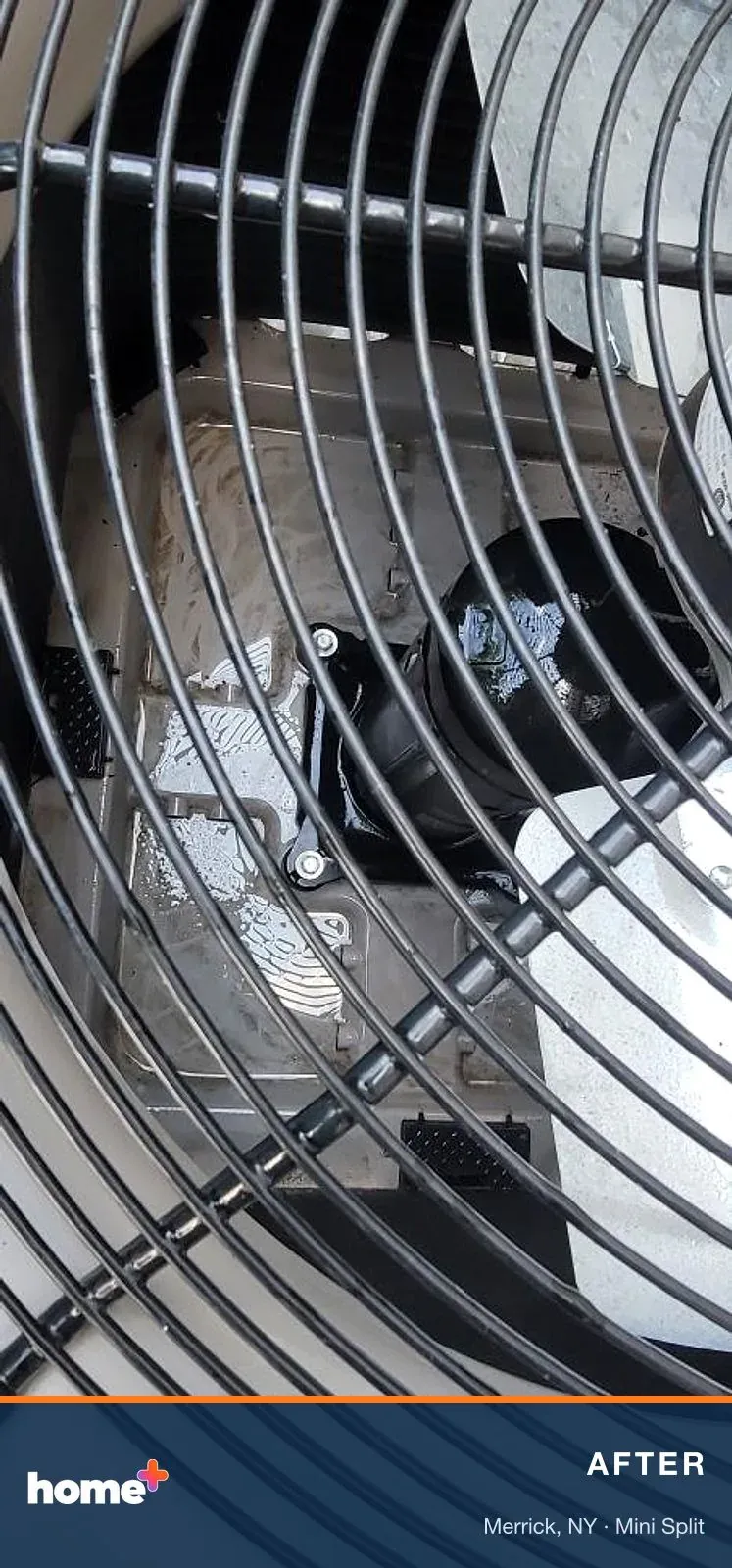 After: a clean base pan and compressor, seen through the fan guard once the top went back on.