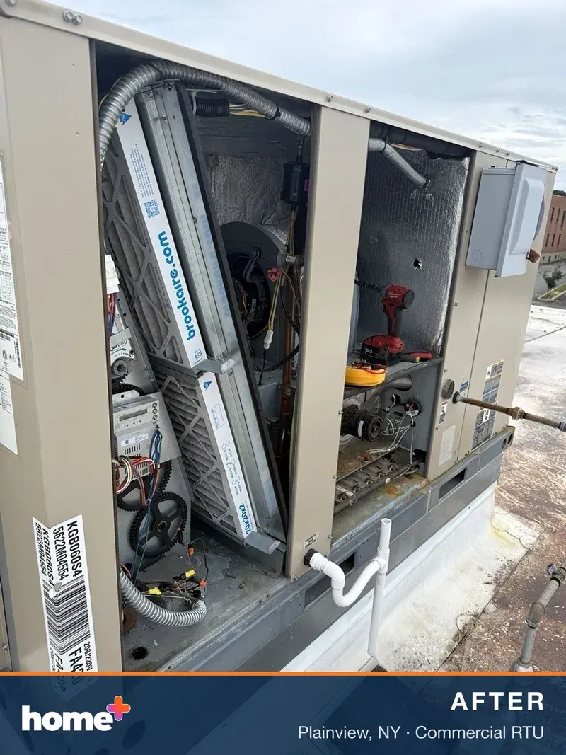 A Lennox rooftop unit opened up, with clean 2-inch pleated filters seated in the filter rack.